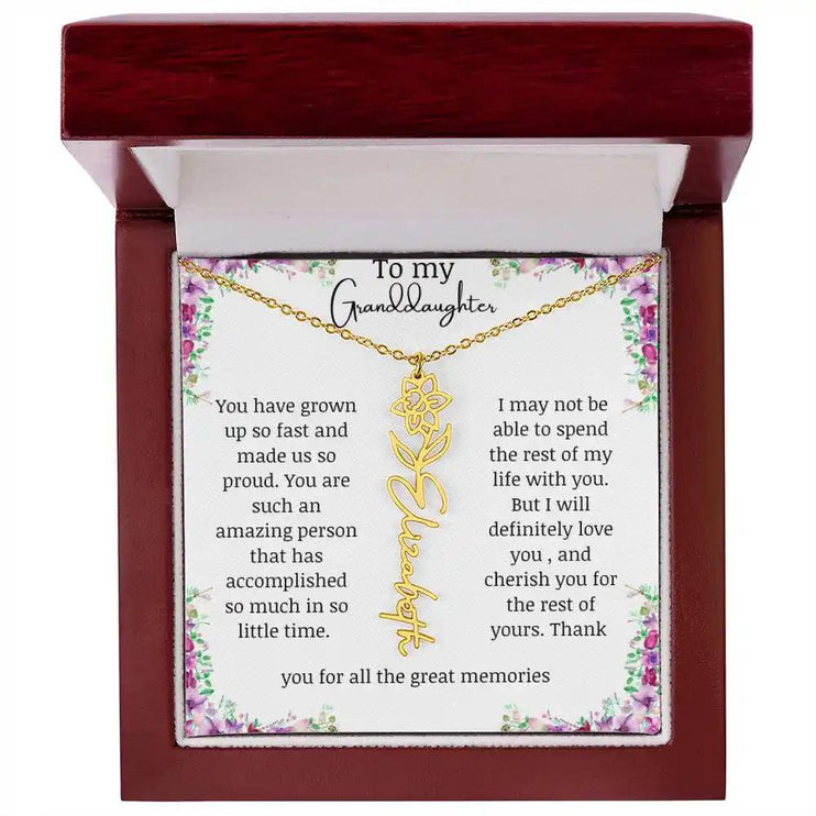 a yellow gold finish March birth flower name necklace in a mahogany box.