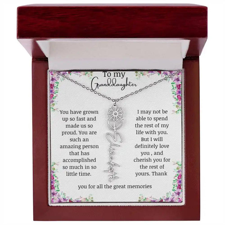 a polished stainless-steel April birth flower name necklace in a mahogany box.