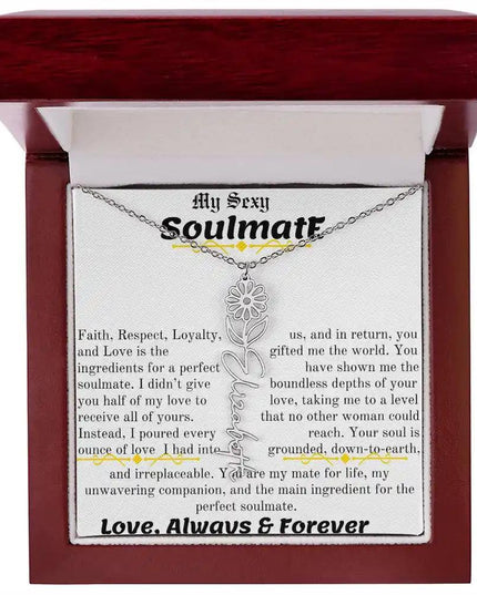 a birth flower name necklace in polished stainless steel for April in a mahogany box.