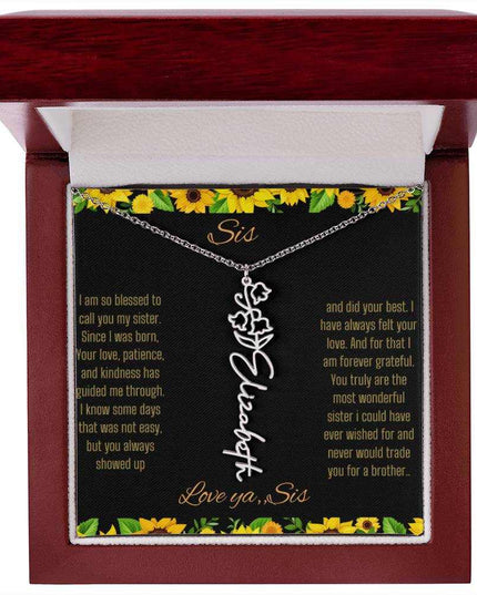Birth Flower Name Necklace with a polished stainless-steel variant of a flower on a To Sis from Sis message card in a mahogany box up close