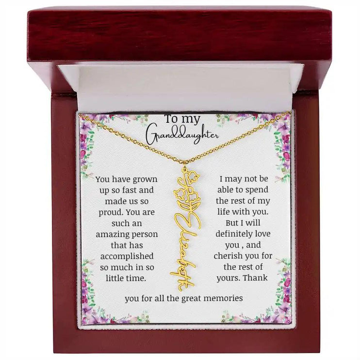 a yellow gold finish May birth flower name necklace in a mahogany box.