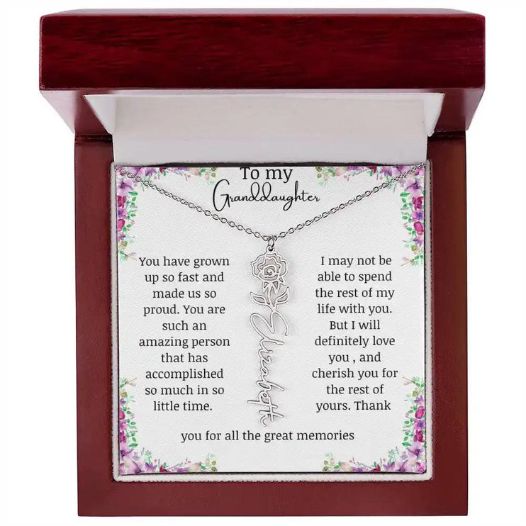 a polished stainless-steel June birth flower name necklace in a mahogany box.