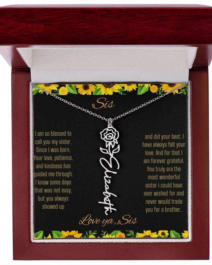 Birth Flower Name Necklace with a polished stainless-steel variant of a flower on a To Sis from Sis message card in a mahogany box up close