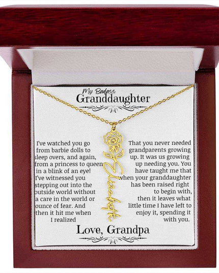 a yellow gold flower name necklace j in a mahogany box.