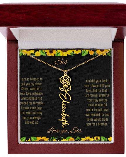 Birth Flower Name Necklace with a yellow gold variant of a flower on a To Sis from Sis message card in a mahogany box up close