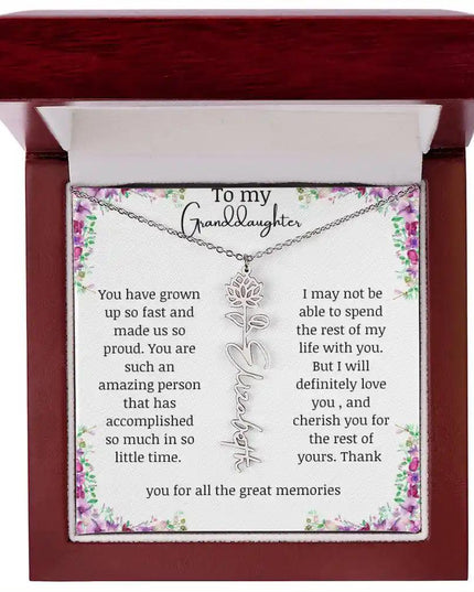 a polished stainless-steel July birth flower name necklace in a mahogany box.