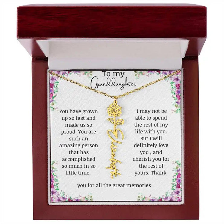 a yellow gold finish July birth flower name necklace in a mahogany box.