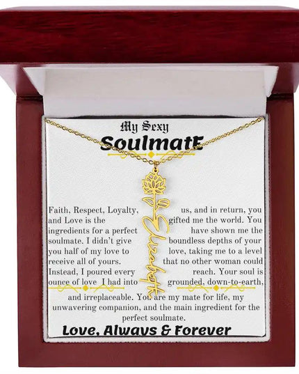 a birth flower name necklace in yellow gold for July in a mahogany box.