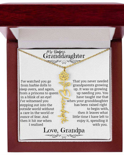 a yellow gold flower name necklace j in a mahogany box.