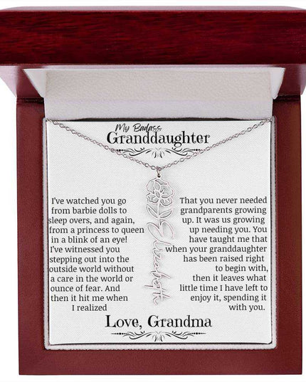 a polished stainless steel flower name necklace for August in mahogany box