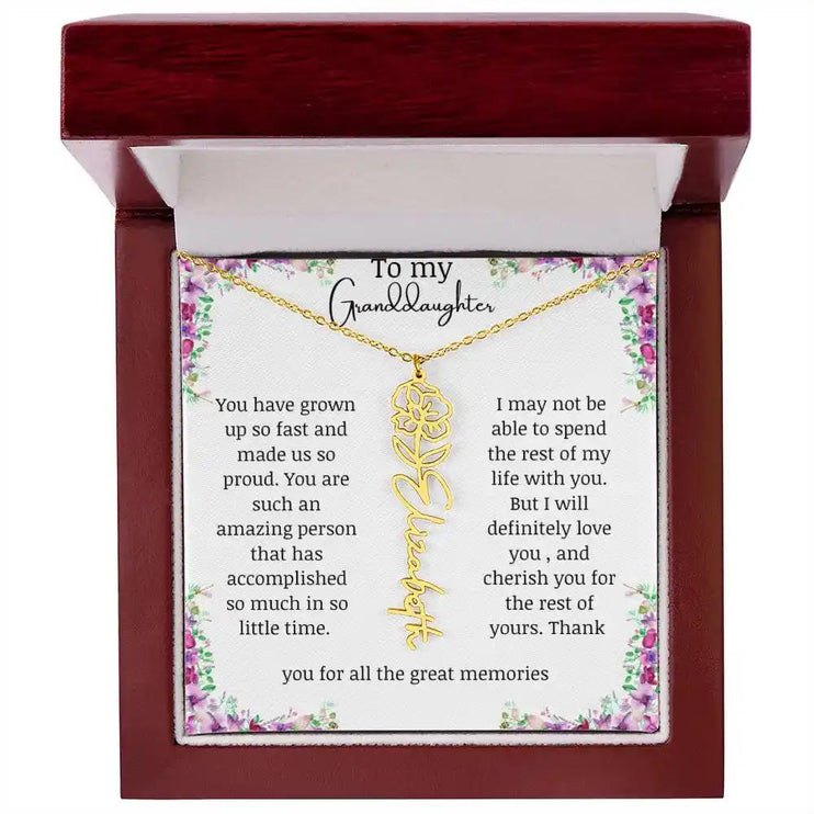 a yellow gold finish August birth flower name necklace in a mahogany box.