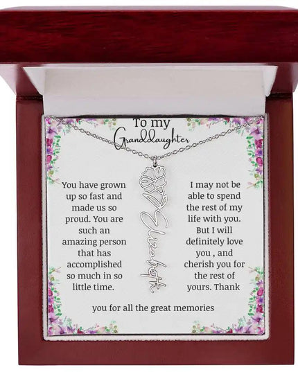 a polished stainless-steel September birth flower name necklace in a mahogany box.