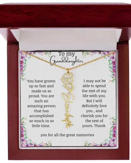 a yellow gold finish September birth flower name necklace in a mahogany box.