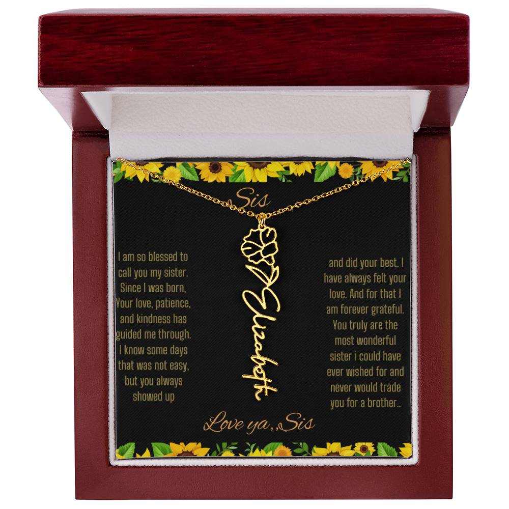 Birth Flower Name Necklace with a yellow gold variant of a flower on a To Sis from Sis message card in a mahogany box up close