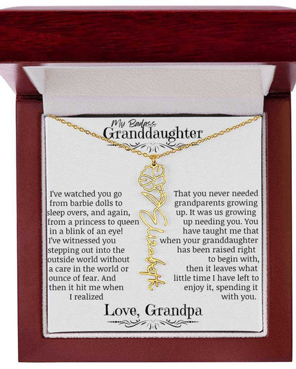 a yellow gold flower name necklace j in a mahogany box.