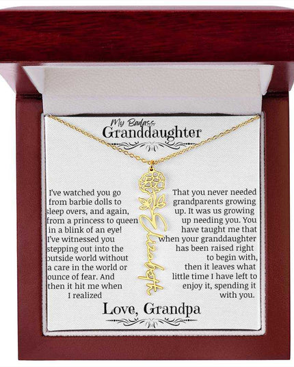 a yellow gold flower name necklace j in a mahogany box.