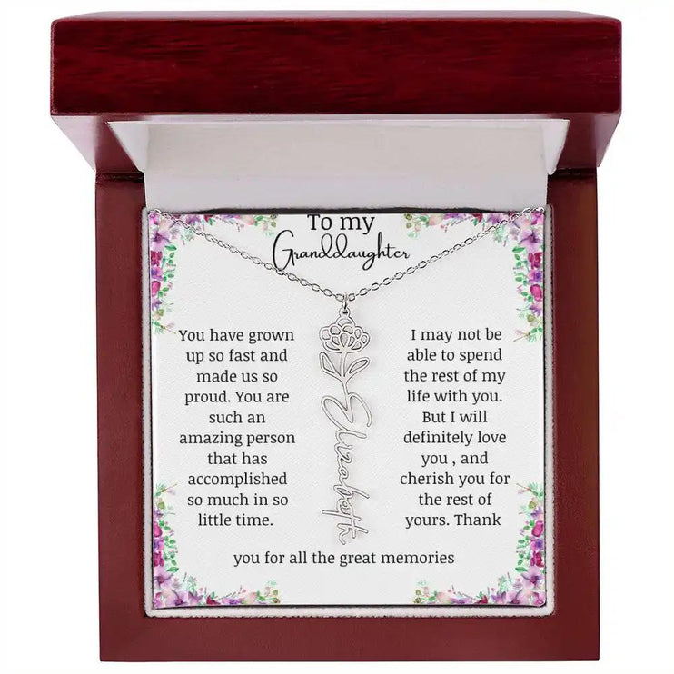 a polished stainless-steel November birth flower name necklace in a mahogany box.