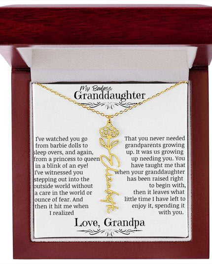 a yellow gold flower name necklace j in a mahogany box.
