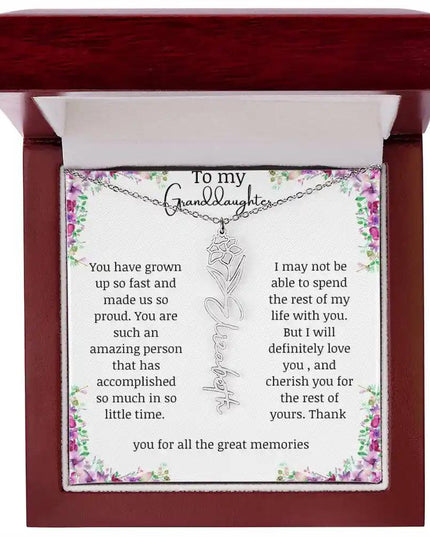 a polished stainless-steel December birth flower name necklace in a mahogany box.