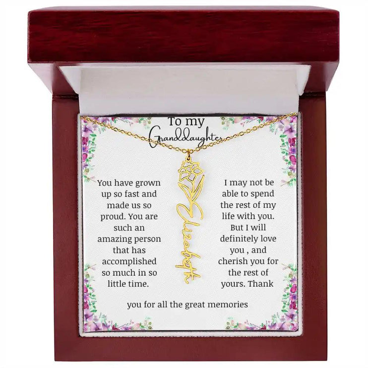 a yellow gold finish December birth flower name necklace in a mahogany box.
