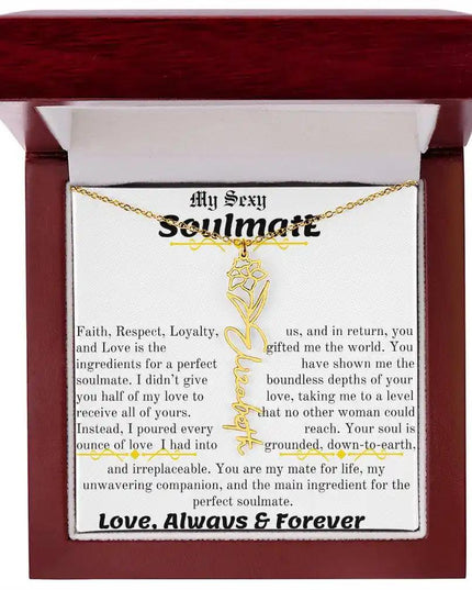 a birth flower name necklace in yellow gold for December in a mahogany box.