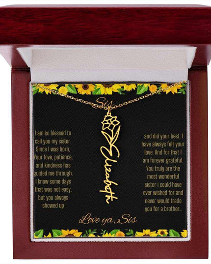 Birth Flower Name Necklace with a yellow gold variant of a flower on a To Sis from Sis message card in a mahogany box up close