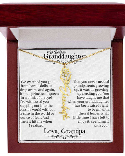 a yellow gold flower name necklace j in a mahogany box.