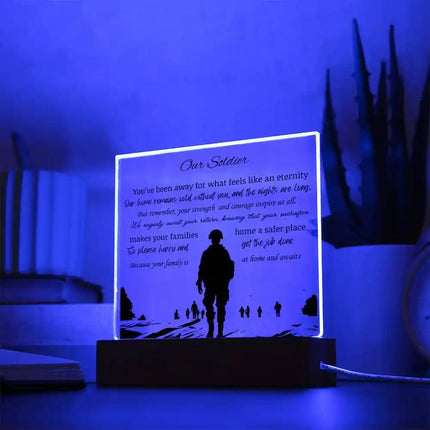 Acrylic Square Plaque square on a white table close up with a blue LED light on the plaque