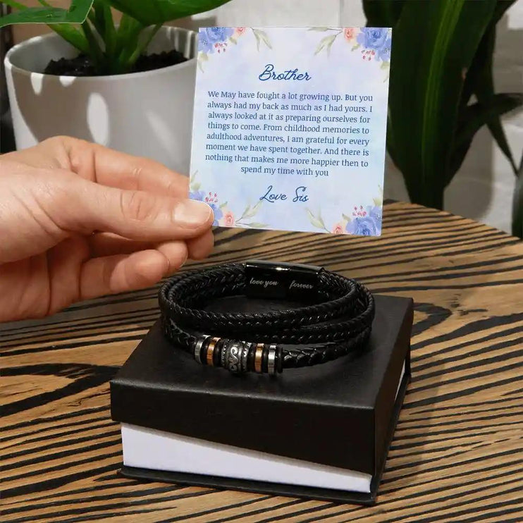 A men's love you forever bracelet on top a two-tone box.