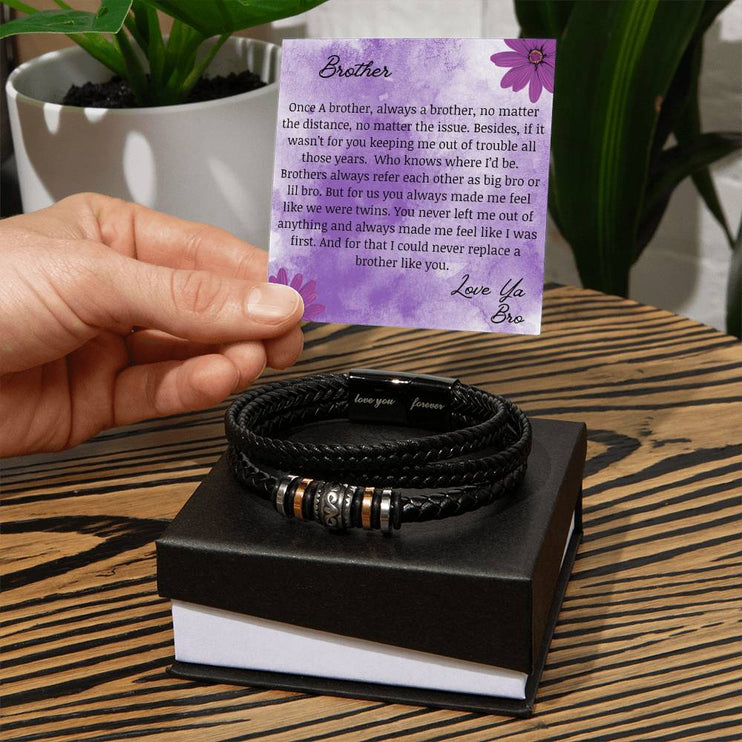 A men's love you forever bracelet on top of a two-tone box.