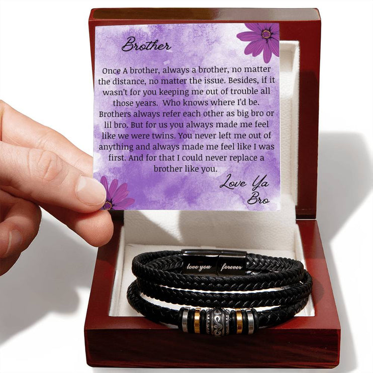 A men's love you forever bracelet in a mahogany box close up.