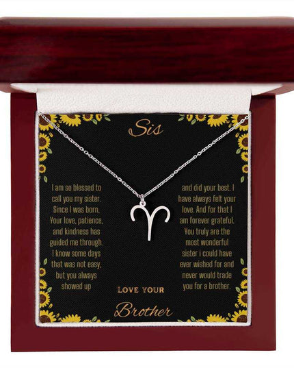 Zodiac Symbol Necklace with a polished stainless-steel Aries charm on a to sis from brother greeting card inside a mahogany box