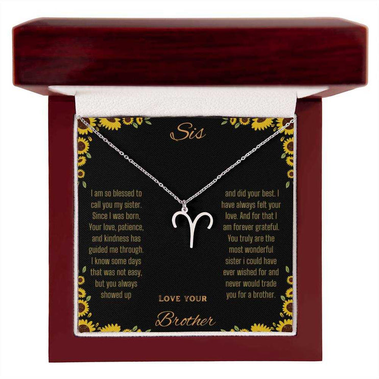 Zodiac Symbol Necklace with a polished stainless-steel Aries charm on a to sis from brother greeting card inside a mahogany box