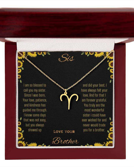 Zodiac Symbol Necklace with a yellow gold finish Aries charm on a to sis from brother greeting card inside a mahogany box