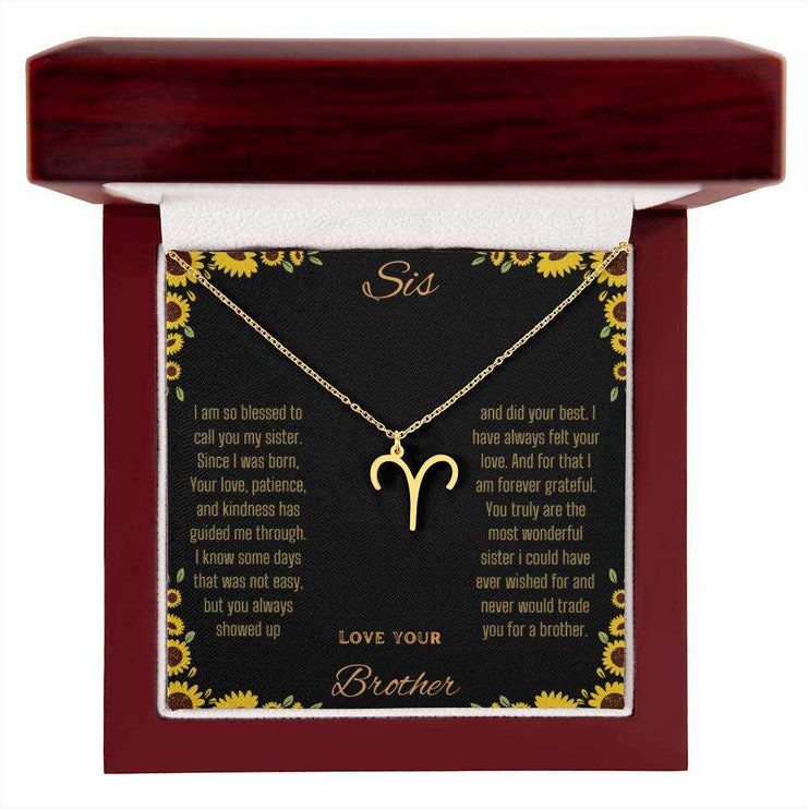 Zodiac Symbol Necklace with a yellow gold finish Aries charm on a to sis from brother greeting card inside a mahogany box