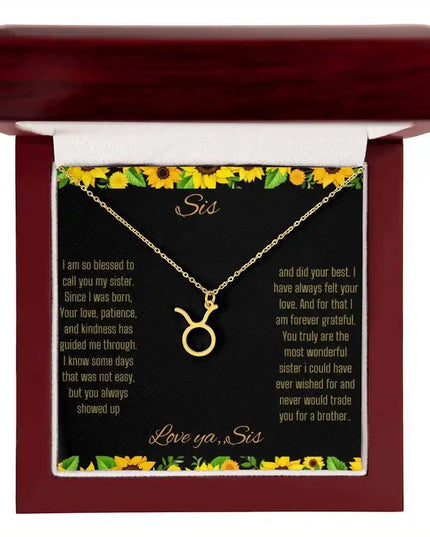 Zodiac Symbol Necklace with a yellow gold finish Taurus charm on a to sis from sis greeting card inside a mahogany box