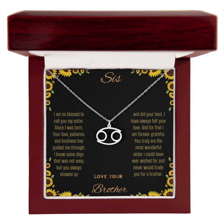 Zodiac Symbol Necklace with a polished stainless-steel Cancer charm on a to sis from brother greeting card inside a mahogany box