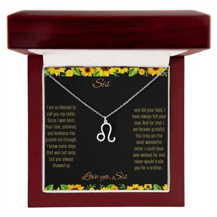 Zodiac Symbol Necklace with a polished stainless-steel Leo charm on a to sis from sis greeting card inside a mahogany box