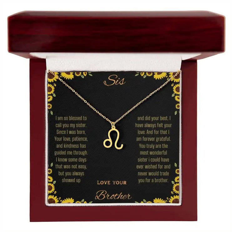 Zodiac Symbol Necklace with a yellow gold finish Leo charm on a to sis from brother greeting card inside a mahogany box
