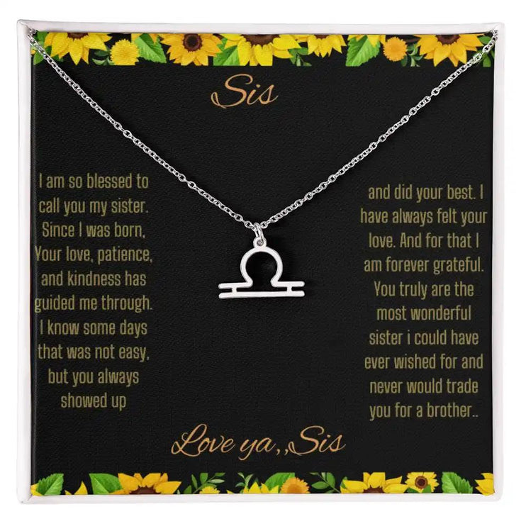 Zodiac Symbol Necklace with a polished stainless-steel Libra charm on a to sis from sis greeting card inside a two-tone box