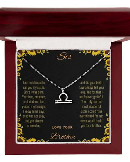 Zodiac Symbol Necklace with a polished stainless-steel Libra charm on a to sis from brother greeting card inside a mahogany box