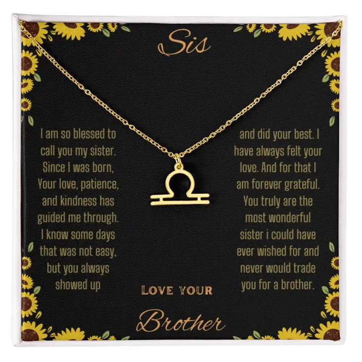 Zodiac Symbol Necklace with a yellow gold finish Libra charm on a to sis from brother greeting card inside a two-tone box box