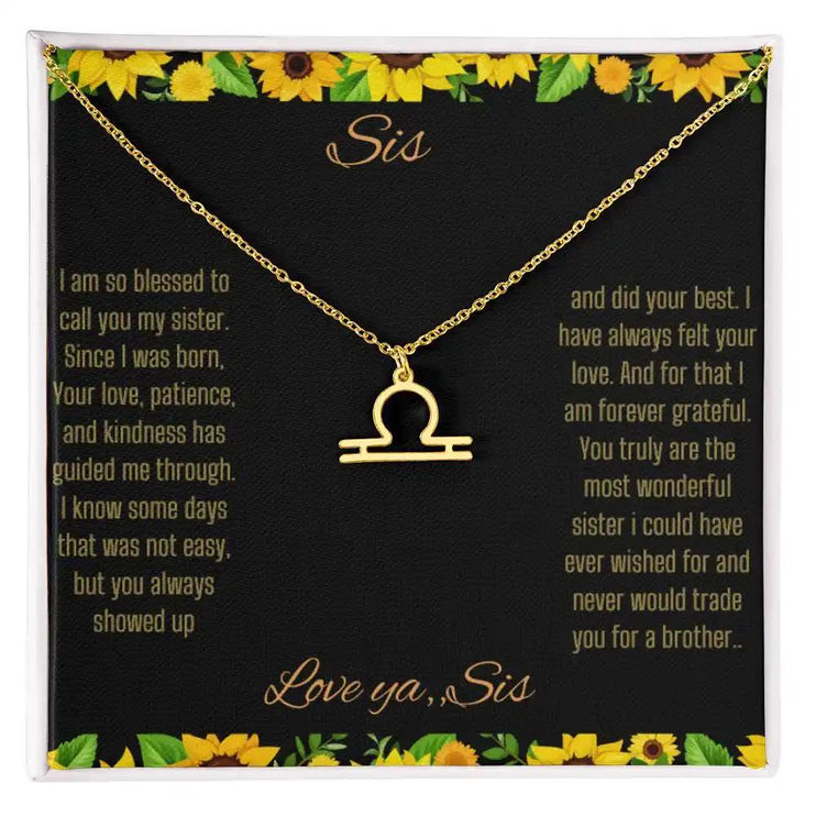Zodiac Symbol Necklace with a yellow gold finish Libra charm on a to sis from sis greeting card inside a two-tonebox