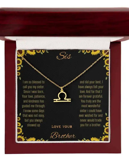 Zodiac Symbol Necklace with a yellow gold finish Libra charm on a to sis from brother greeting card inside a mahogany box