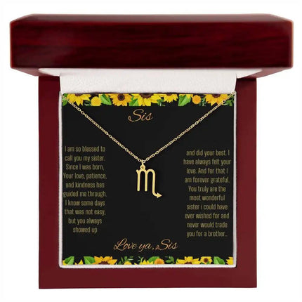 Zodiac Symbol Necklace with a polished stainless-steel Scorpio charm on a to sis from sis greeting card inside a mahogany box