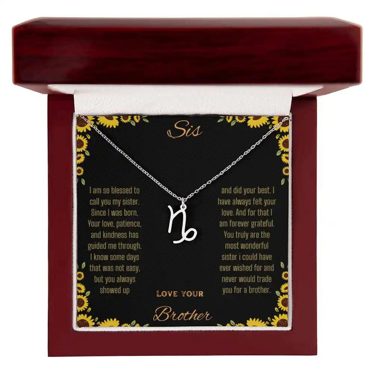 Zodiac Symbol Necklace with a polished stainless-steel Capricorn charm on a to sis from brother greeting card inside a mahogany box