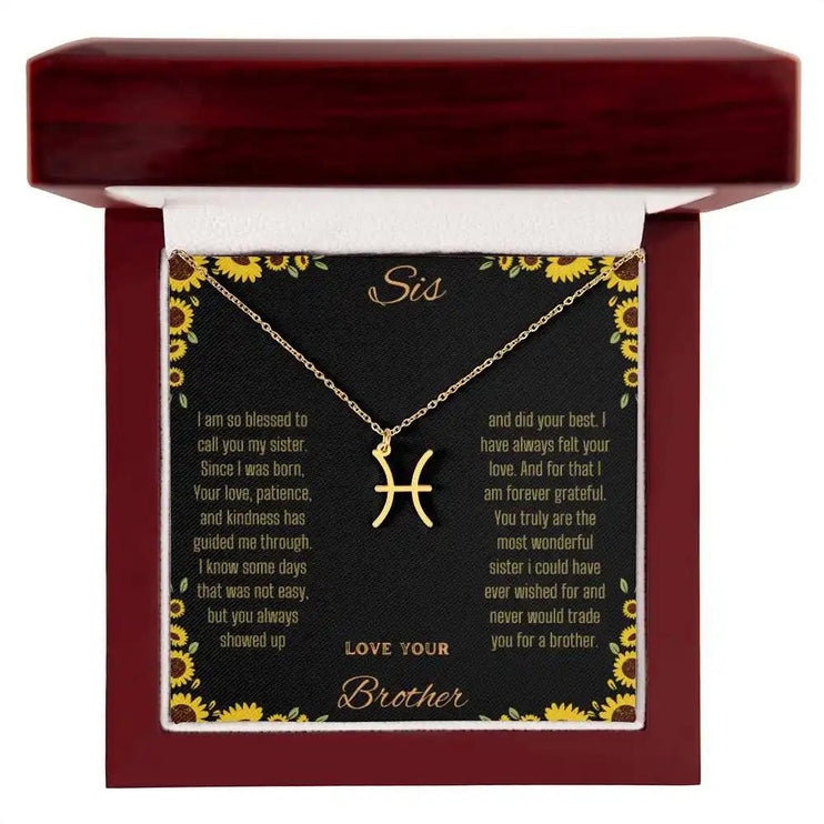Zodiac Symbol Necklace with a yellow gold finish Pisces charm on a to sis from brother greeting card inside a mahogany box