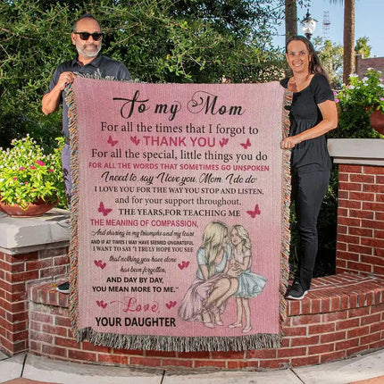 Heirloom Woven Blanket with 2 people holding it up