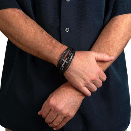 cross leather bracelet on a model's wrist showing both arms crossed