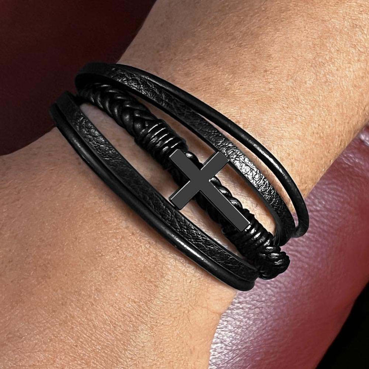 cross bracelet on model's wrist up close